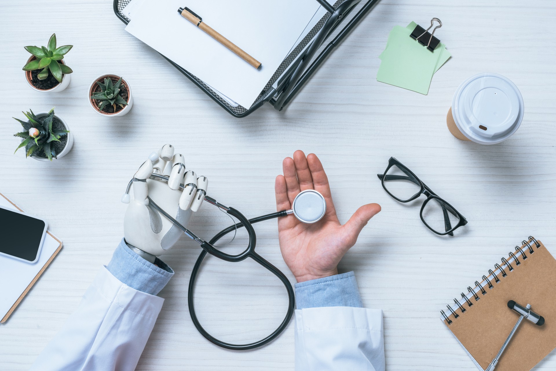 partial view of male doctor with prosthetic arm holding stethoscope